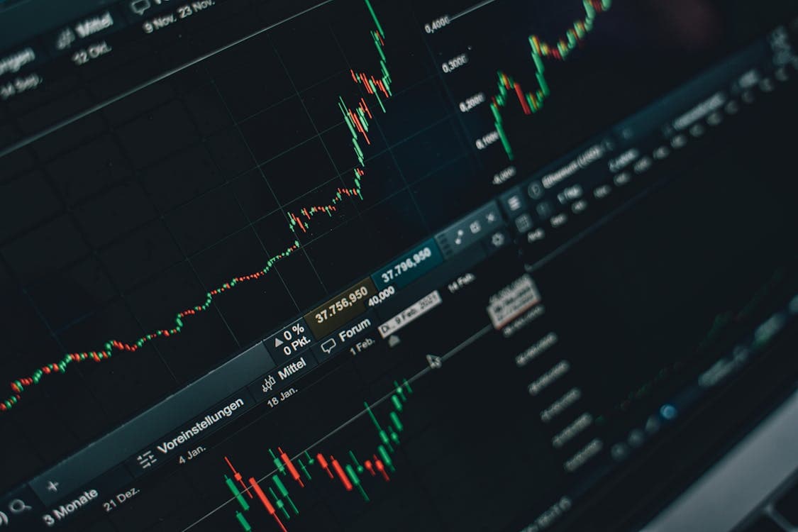Multiple trading charts and graphs on laptop screen